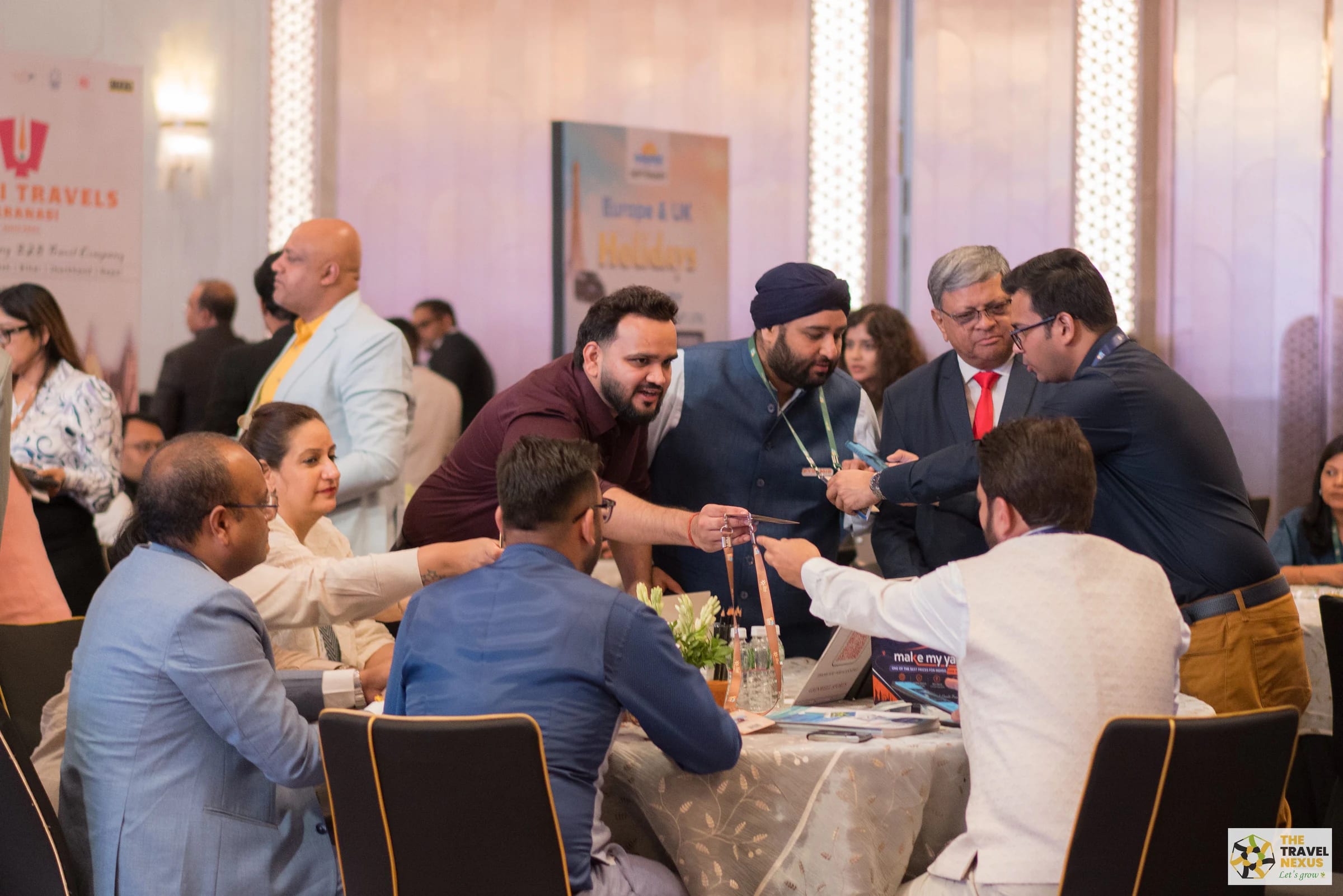 Travel Nexus members exchanging business material around a networking table