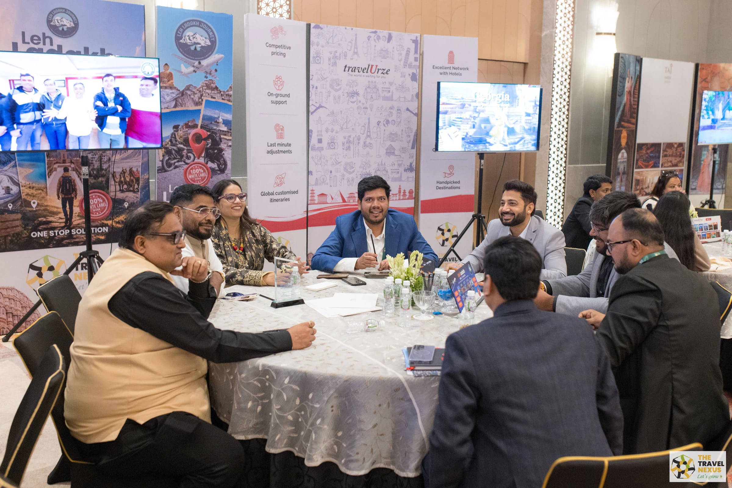 Travel professionals in discussion around an exhibitor meeting table