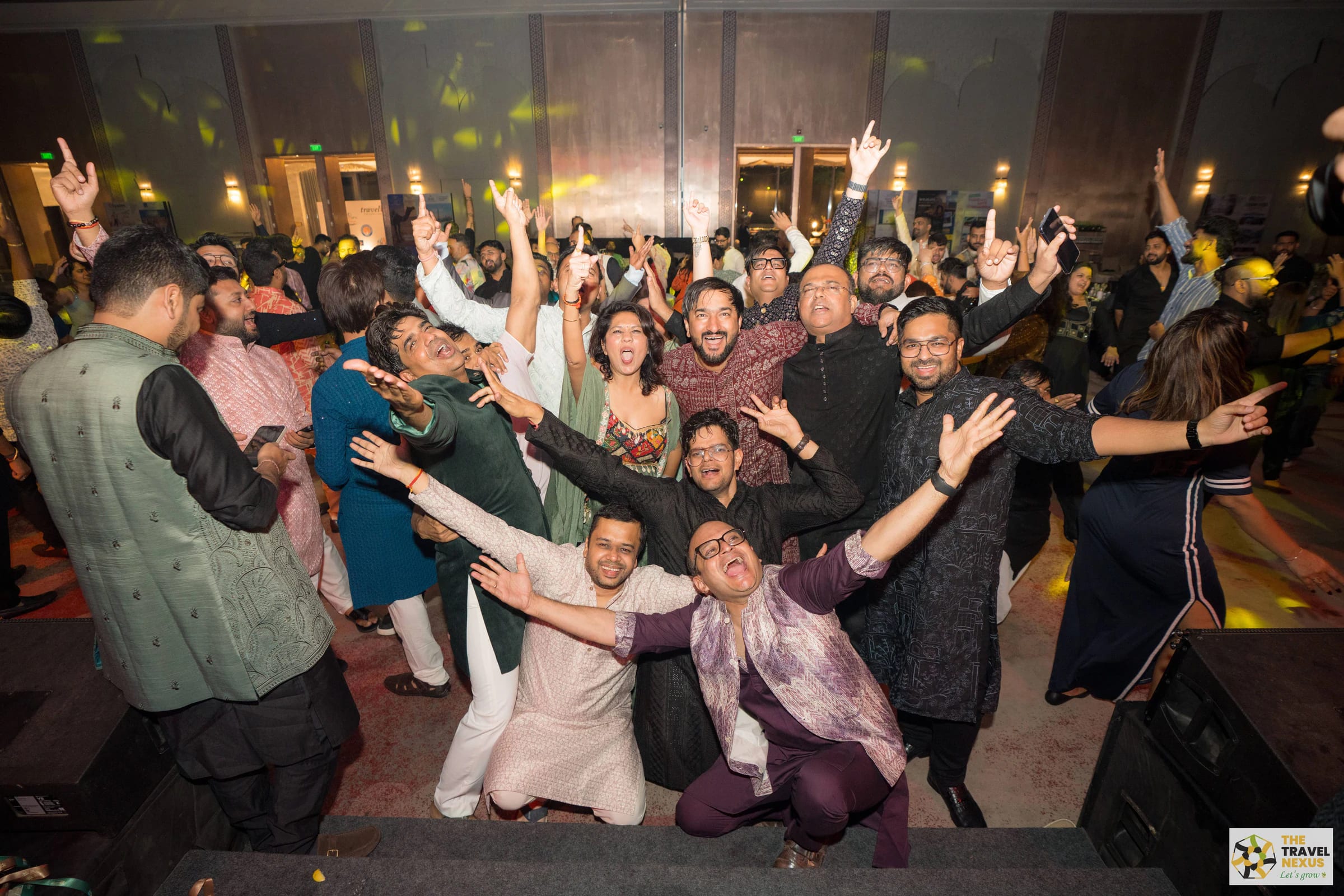 A lively group of Travel Nexus members celebrating together on the dance floor